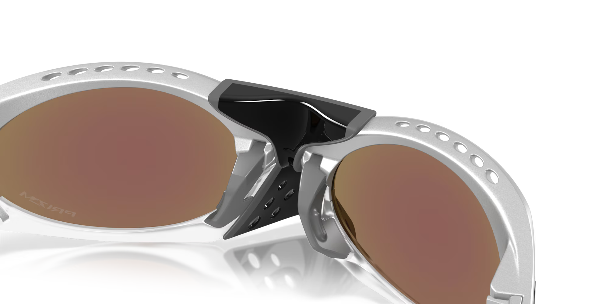 Close-up of Plantaris X-Silver Frame sunglasses by Machina - Wearable Technology, featuring silver frames, brown-tinted lenses, a black vented nose bridge with multiple holes for ventilation, and adjustable temples. Set against a plain white background.