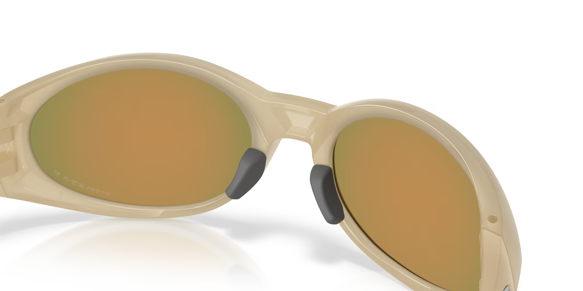 Close-up of Eye Jacket™ Redux Latitude Collection by Machina - Wearable Technology: beige sunglasses with a bold oval silhouette, round reflective gold lenses, and black nose pads against a white background.