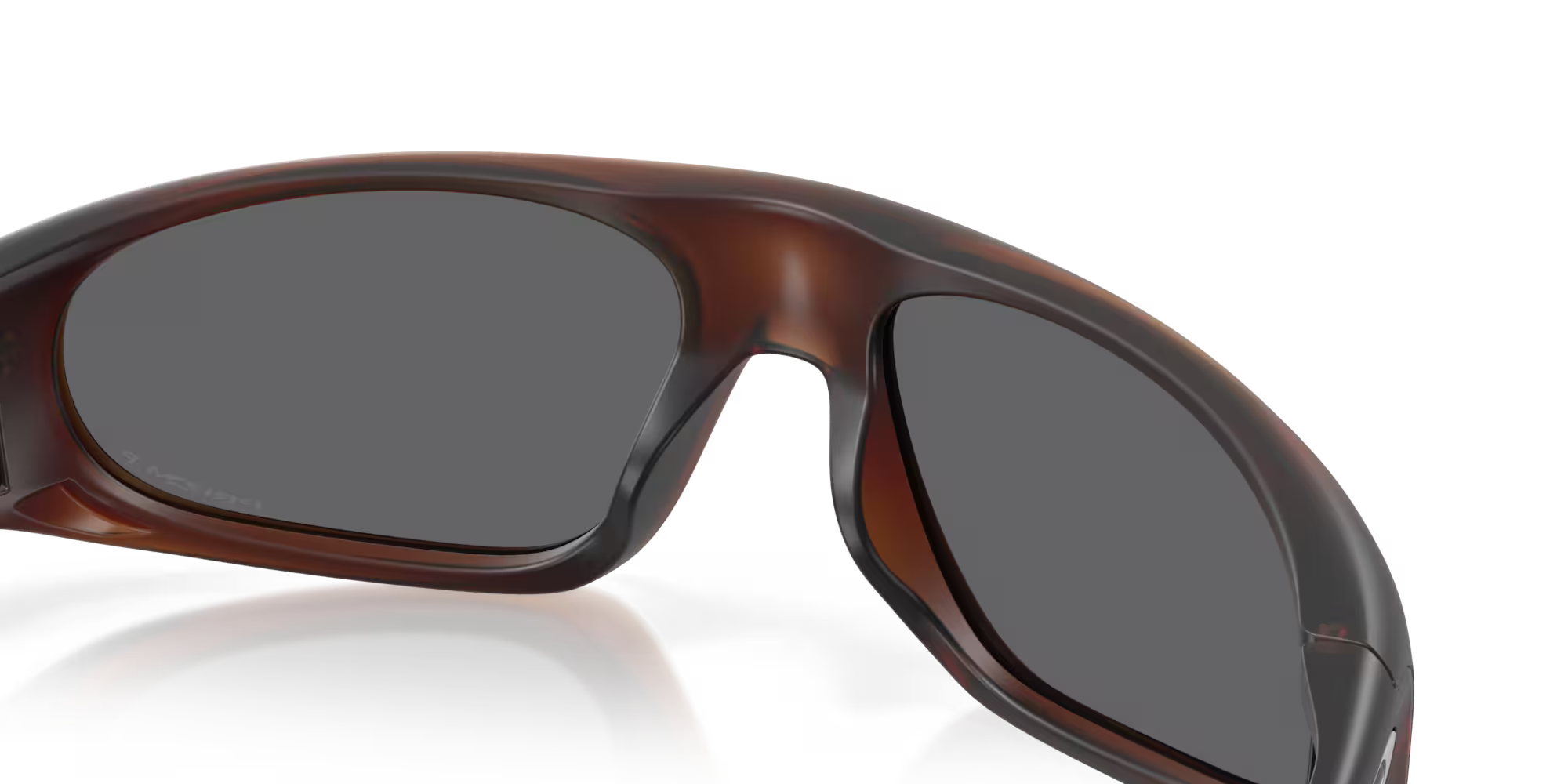Close-up of the upper half of Machina - Wearable Technology Neoforma Matte Rootbeer Frame sunglasses, with wraparound curves and dark lenses, shown against a plain white background.