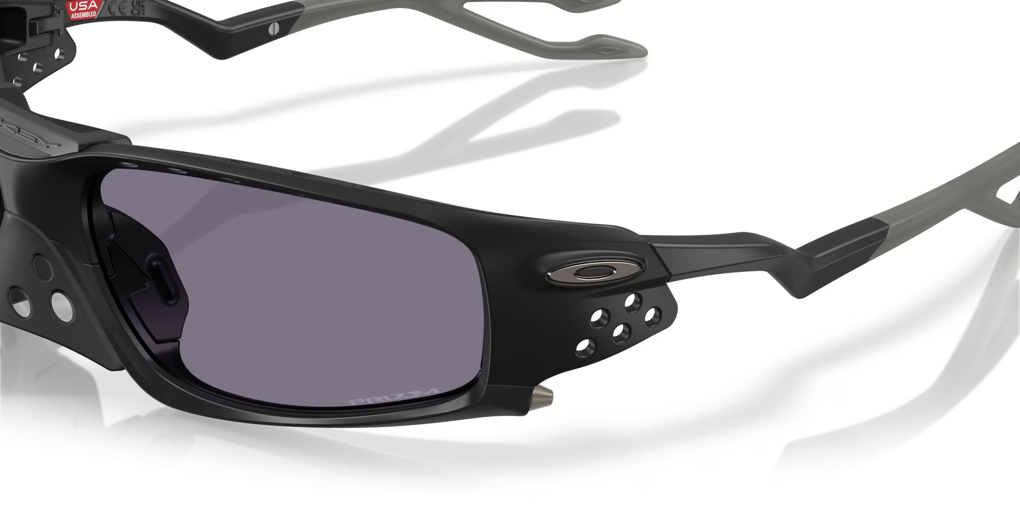 Close-up of Machina - Wearable Technology Plantaris SQ Matte Black sports sunglasses with purple-tinted square lenses, small ventilation holes on the frame, and the Machina logo next to the right lens.