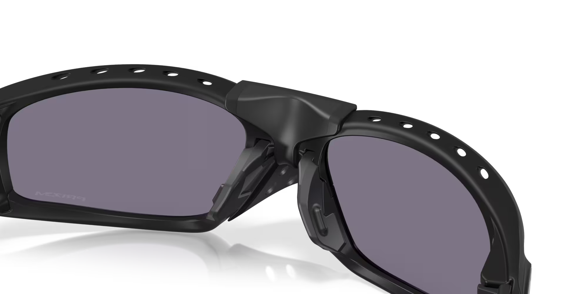 Close-up of Plantaris SQ Matte Black sunglasses by Machina - Wearable Technology, featuring square purple-tinted lenses, a vented frame with circular holes along the top edge, and a sturdy bridge.