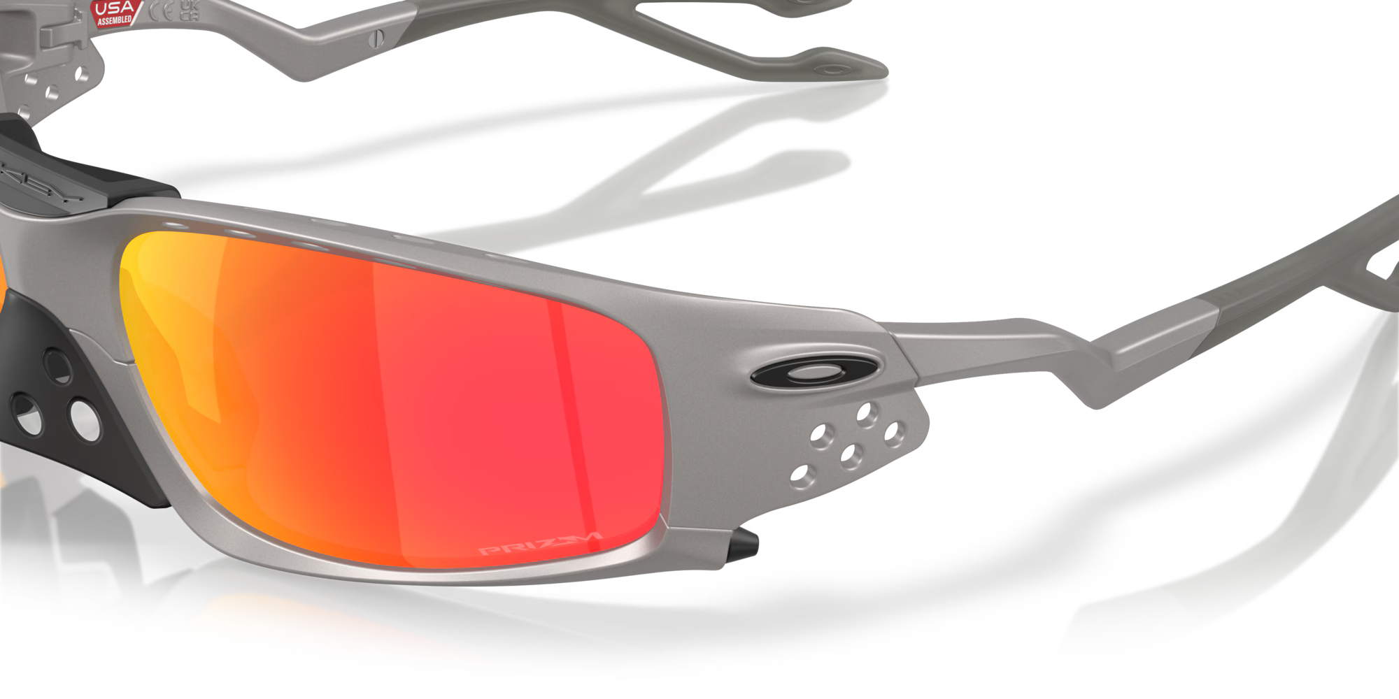 Close-up of Machina Plantaris SQ Titanium Frame sunglasses with metallic gray square lenses, red-orange mirrored finish, vent holes on the edges, a vented nose piece, and Machina - Wearable Technology branding on the side.
