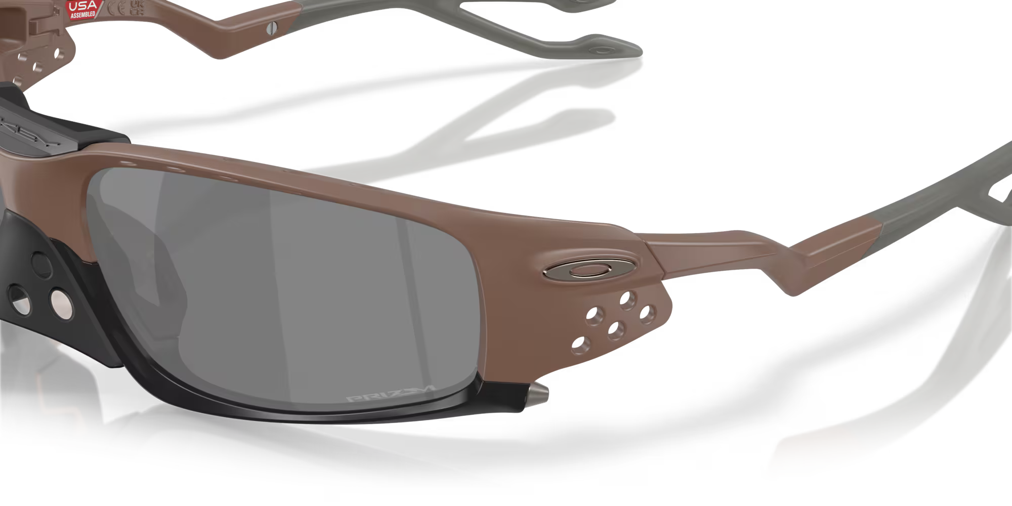 Close-up of Machina - Wearable Technology Plantaris SQ Matte Mahogany sunglasses with black square lenses, multiple ventilation holes on the frame, and Machina logo on the side. Set against a white background.