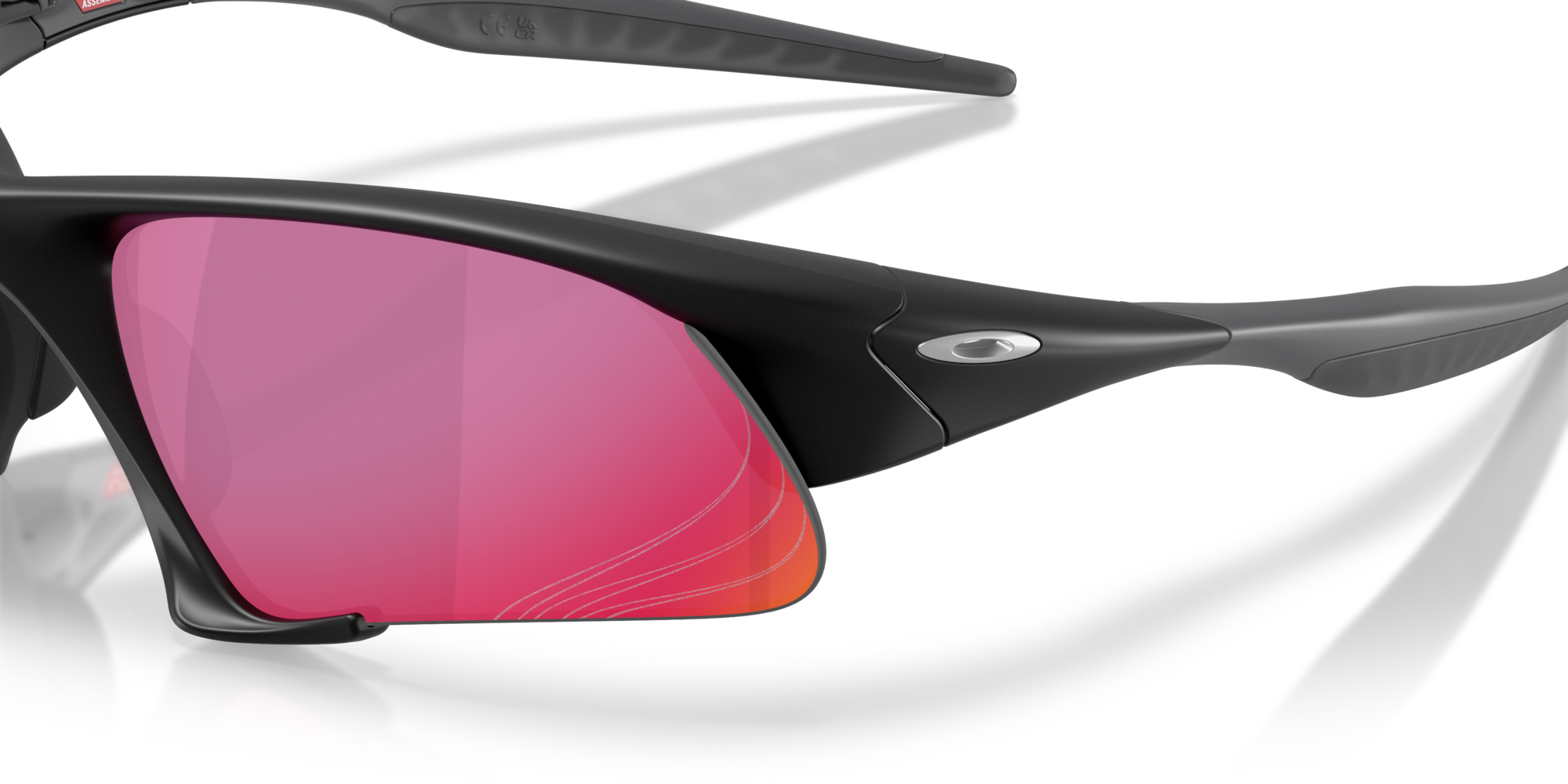 Close-up of Suture Jacket® Matte Black sport eyewear by Machina - Wearable Technology: black crossover sunglasses with pink mirrored lenses, sleek design, high-wrap curved shape, and a small silver logo.