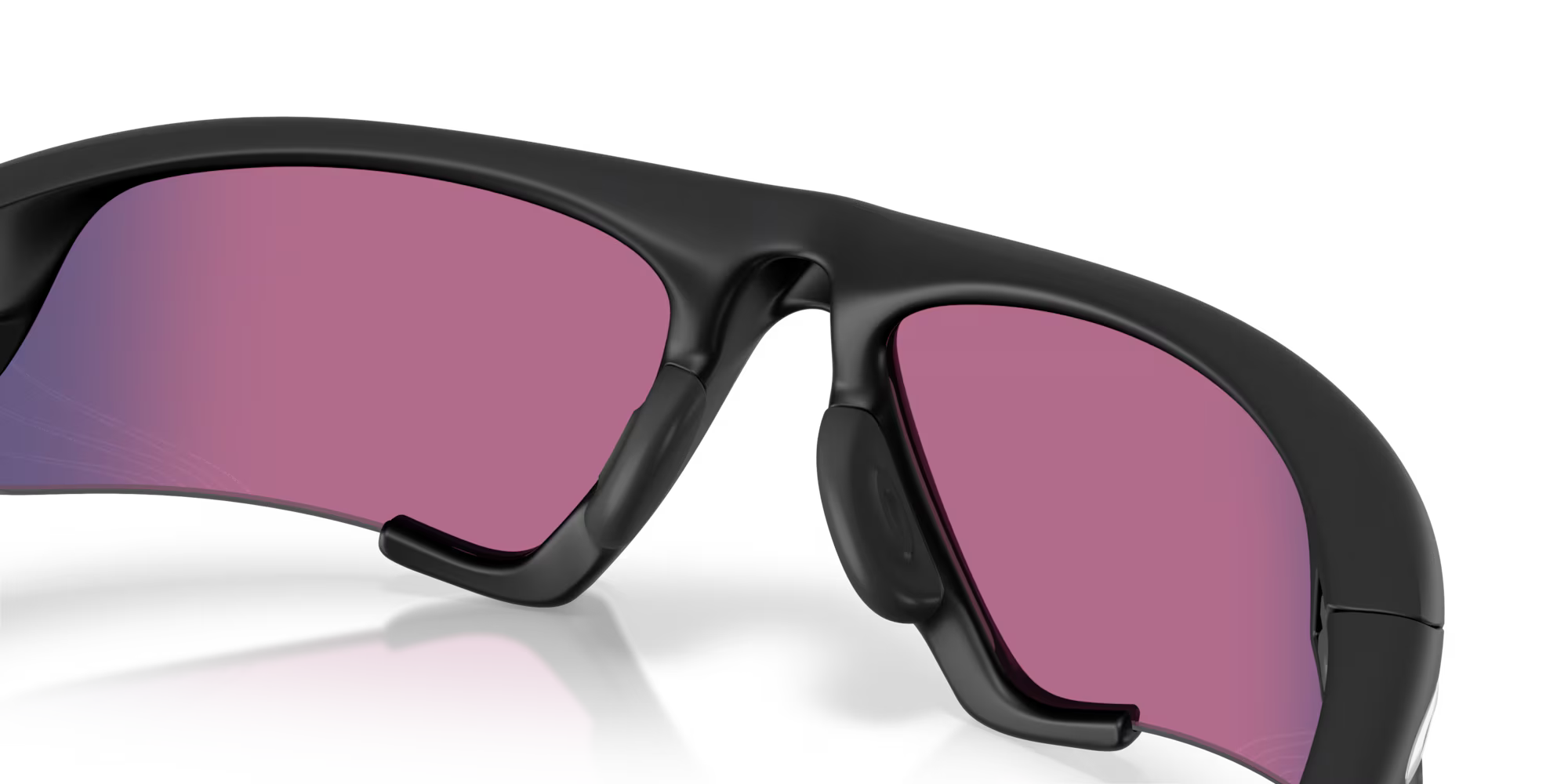 Close-up of the Suture Jacket® Matte Black Frame sport eyewear by Machina - Wearable Technology, with bold black frames, pink-tinted lenses, a curved sporty design, and a central nose pad. White background highlights these high-wrap sunglasses.