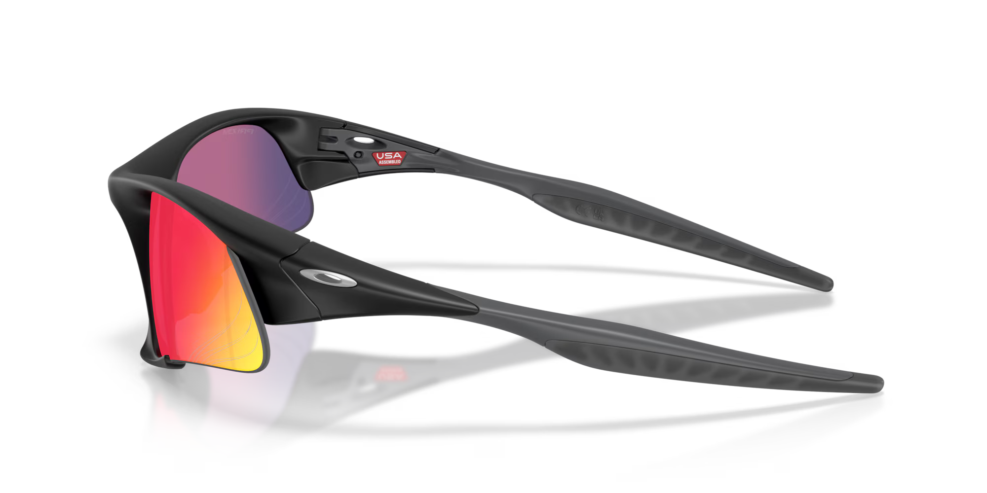 The Machina Suture Jacket® Matte Black Frame sport eyewear features bold black frames, red-orange mirrored lenses, and a small USA sticker inside the frame, displayed against a plain white background.