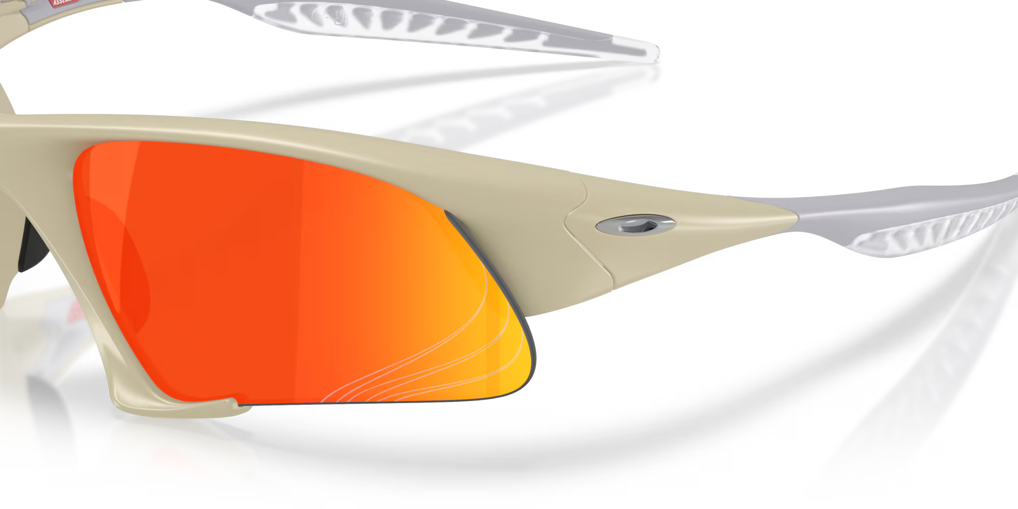 Close-up of Suture Jacket® Matte Sand sunglasses by Machina - Wearable Technology, featuring reflective orange-red lenses, silver Machina logo on the frame, and textured white arms against a plain white background.