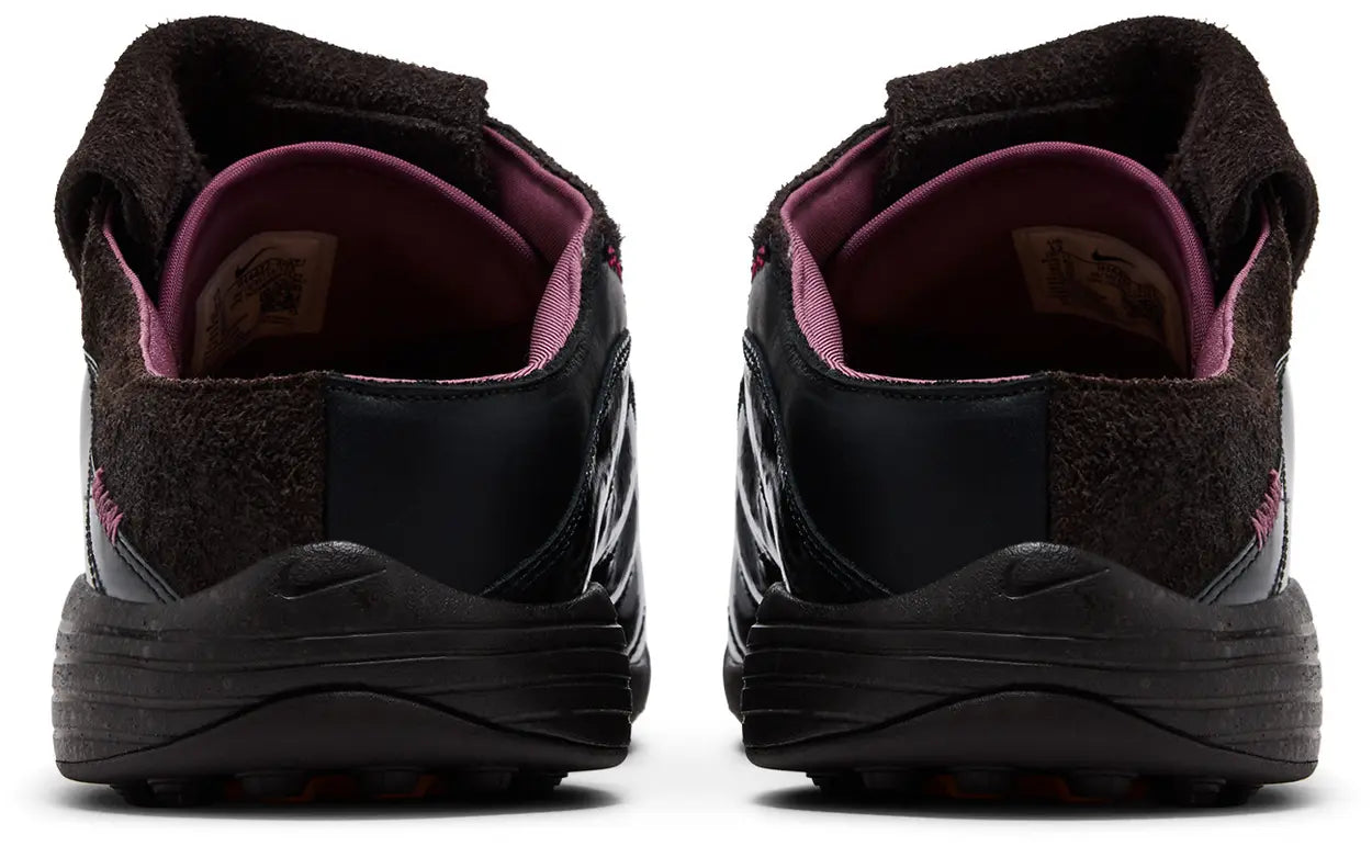 The Kids of Immigrants x Nike T-90 Mule 'Velvet Brown' by Machina Wearable Technology features black uppers, dark brown suede accents, purple inner lining, and subtle Nike branding on the heel and sole, shown from the back.