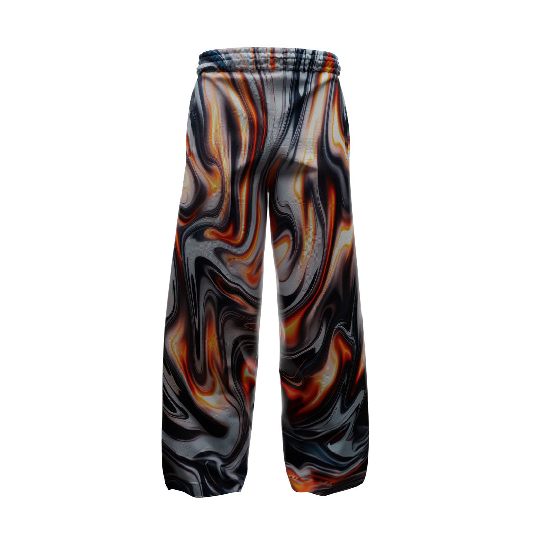 The CHROMED FLAMES TRACKSUIT from Machina - Wearable Technology showcases stylish full-print baggy pants with an abstract swirling pattern in black, white, orange, and yellow against a crisp white background. Crafted from premium materials, the elastic waistband and wide-leg design enhance both comfort and fashion-forward appeal.