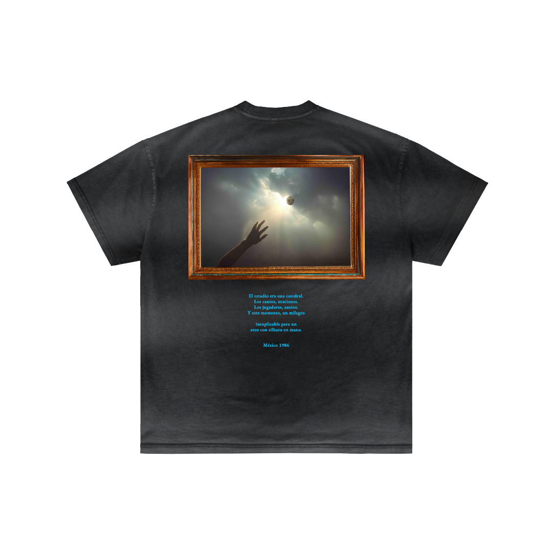 The San Maradona by Machina - Wearable Technology is a black t-shirt with a framed graphic of a hand reaching for a floating sphere, inspired by Maradona’s Mexico 1986 moment, and features centered blue text on the back.
