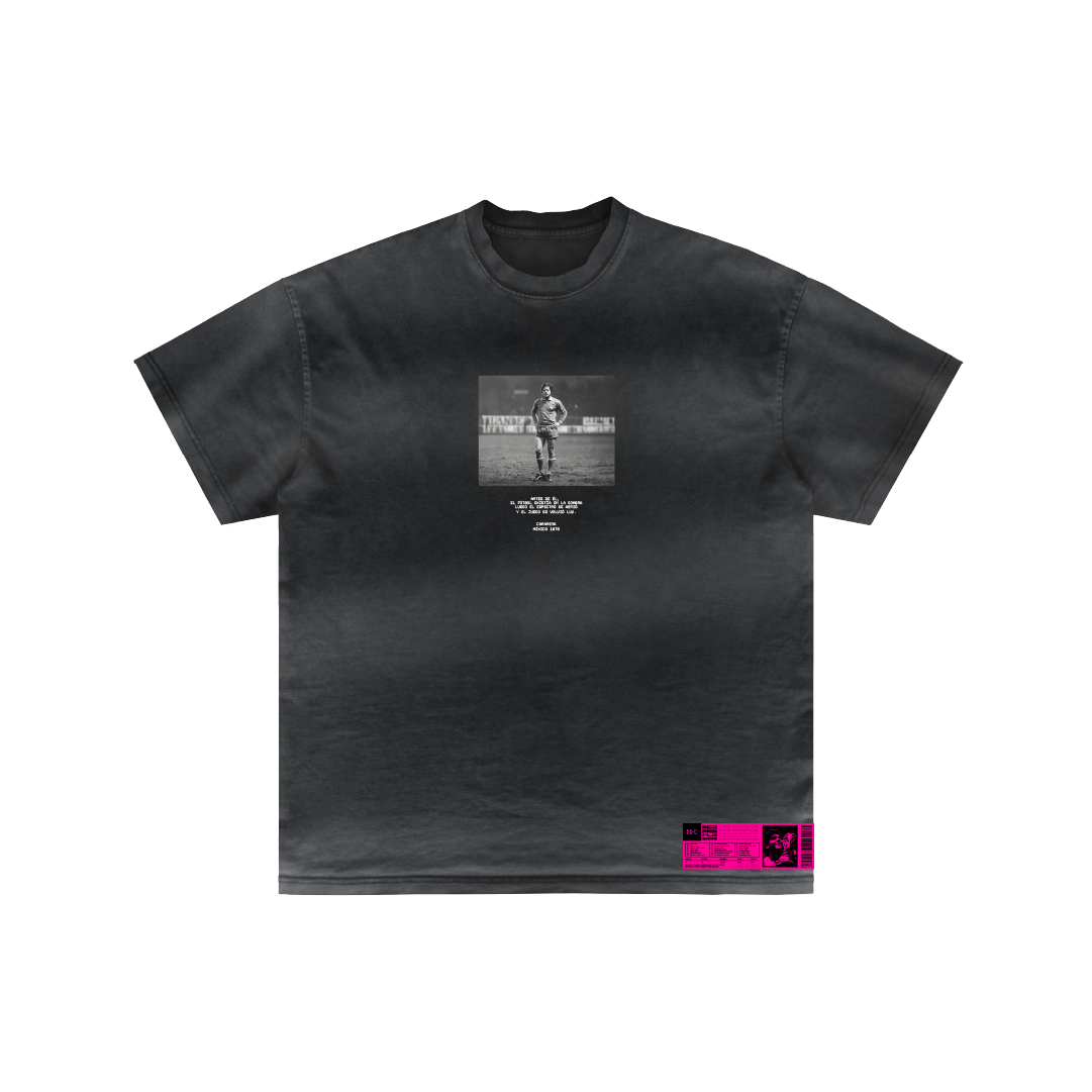 The Camarena La Leyenda by Machina - Wearable Technology is a black T-shirt with a small black-and-white photo of a runner, text below the image, and a bright pink graphic label inspired by color TV pioneer Guillermo González Camarena.
