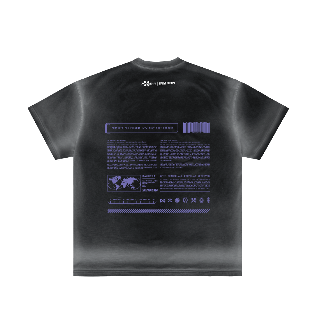 The image showcases a black "Pie Pequeño" T-shirt by Machina - Wearable Technology, featuring white and purple text and graphics on the back. These include a small world map, barcode, and abstract designs with a tech-themed nod to covert ops, complete with multiple lines of unreadable text.