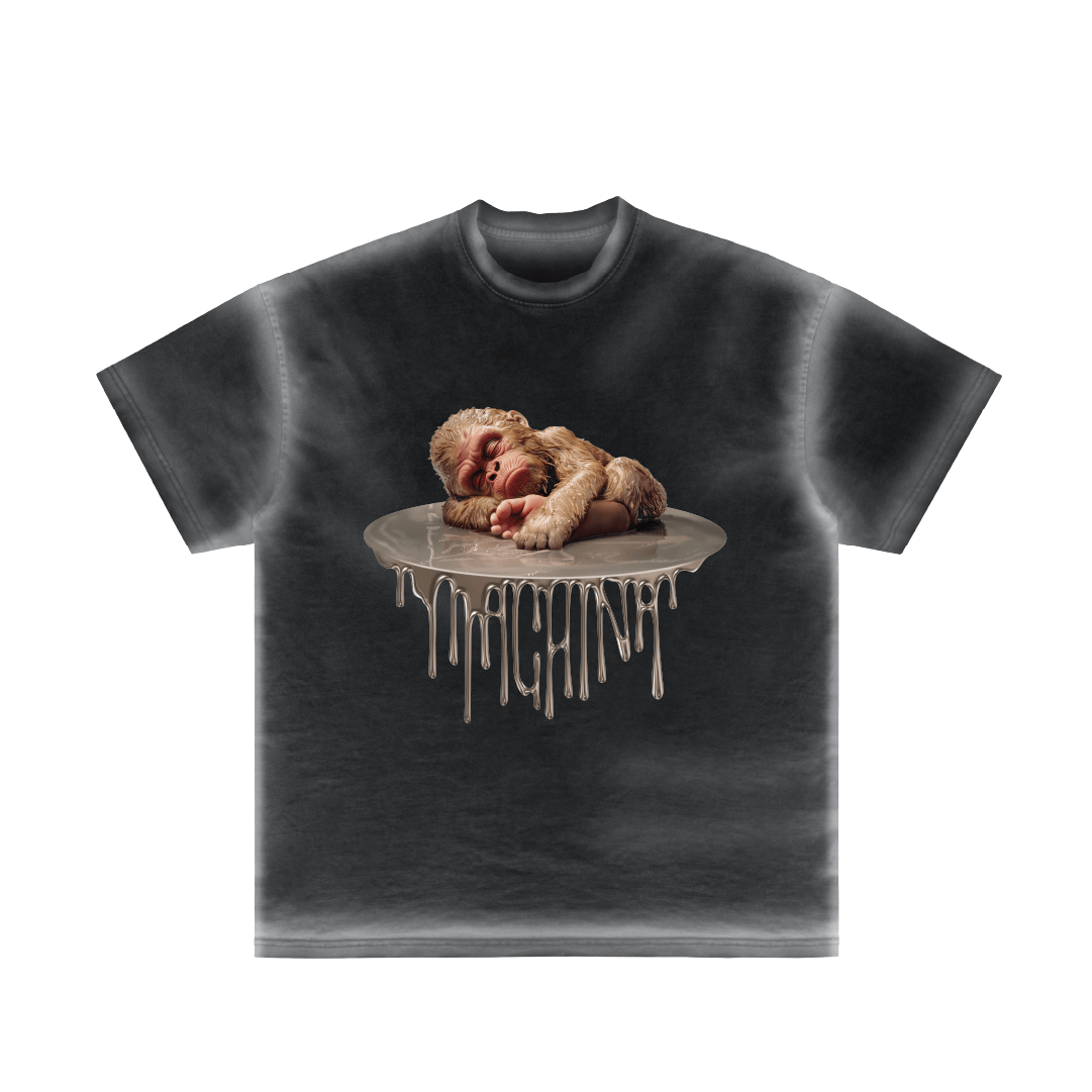 Introducing the Pie Pequeño by Machina - Wearable Technology: a black t-shirt showcasing a graphic of a sleeping monkey resting on a silver, melting surface with drips descending, evoking an urban jungle atmosphere where Bigfoot might hide unnoticed.