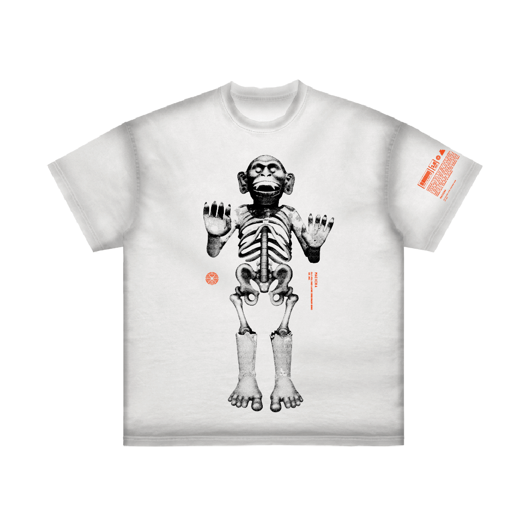 Introducing the Mictlantecuhtli by Machina - Wearable Technology: a white T-shirt adorned with a striking graphic of an upright monkey skeleton on the front, capturing the mystical essence of the Coatlicue statue. The right sleeve features vibrant orange text, offering a contemporary touch to this Aztec goddess-inspired design.