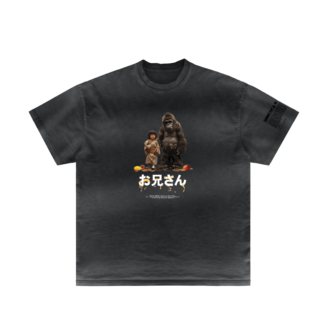 The "Big Brother" T-shirt by Machina - Wearable Technology features a black design with a captivating graphic of a small person and large gorilla, emphasizing a mystical bond amidst vibrant objects. Beneath the image, Japanese text enhances its enigmatic allure.
