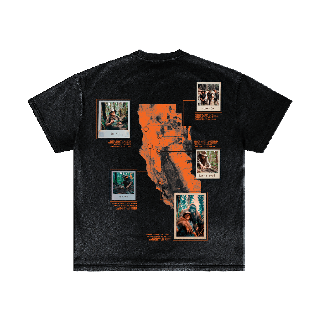 The La Sombra T-shirt by Machina - Wearable Technology is a black garment featuring an orange map design on the back, highlighting gorillas and capturing the essence of wilderness allure. It includes inscriptions such as "Gorillas and Sante, 1979," along with outlined sections and numbered circles, evoking memories of Pacific Northwest adventures.