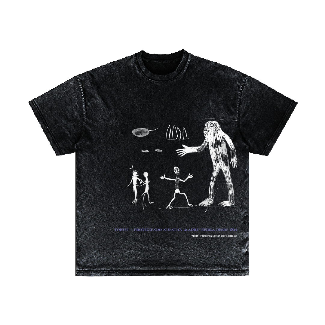 A black t-shirt from Machina - Wearable Technology titled "Los Guardianes" showcases abstract white drawings, including two humanoid figures, a mysterious cryptid that resembles Bigfoot, various floating shapes and symbols. Near the bottom of the design, subtle purple text conveys an evolutionary statement.