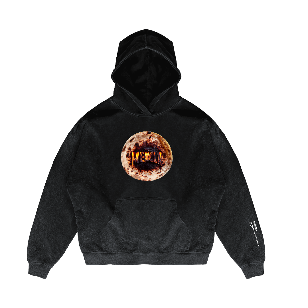 Introducing the Tortilla Milagro Hoodie by Machina - Wearable Technology: a black heavyweight French terry cotton hoodie showcasing a circular emblem with "MEMORIA" at its center, resembling a textured, reddish-brown stone. The right sleeve features subtle text, adding to the hoodie's stylish and unique appeal.
