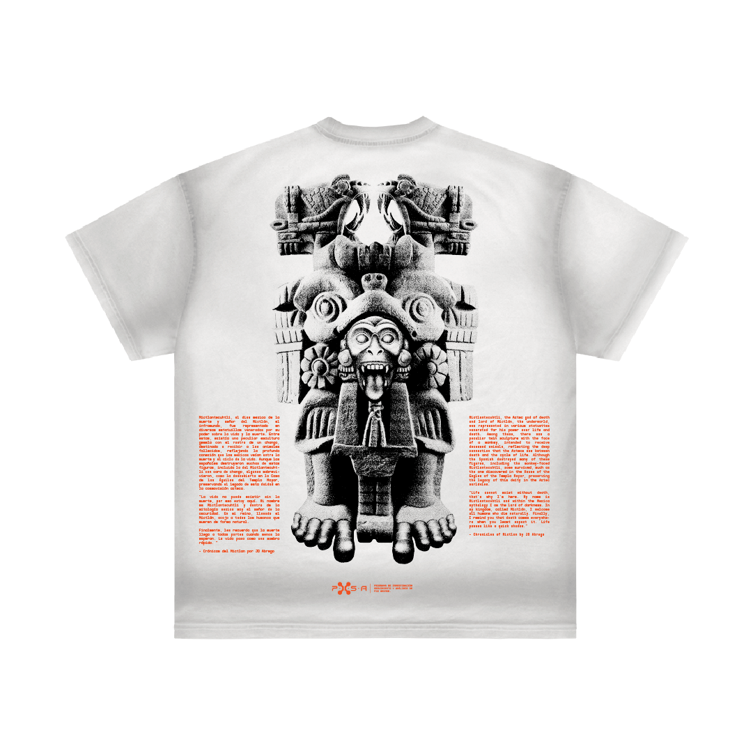 A white t-shirt from Machina - Wearable Technology, named "Coatlicue," showcases a detailed grayscale print of an ancient statue with intricate designs. Inspired by Aztec goddess motifs similar to the Coatlicue statue, it features bold red text on both sides for a striking contrast.