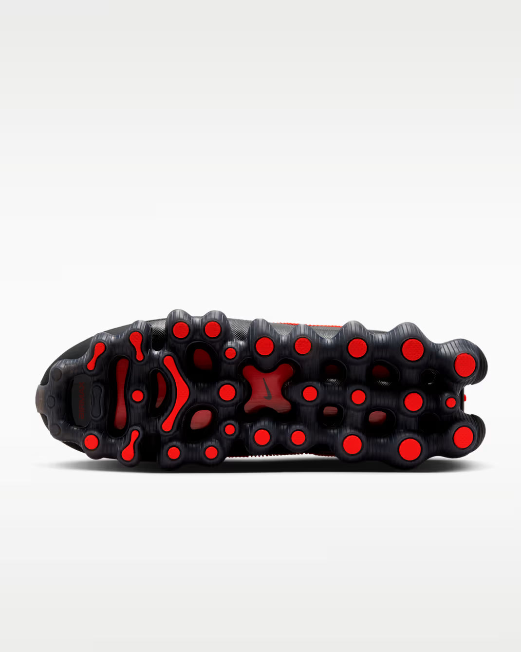 The image shows the black outsole of the Machina Wearable Technology Air Liquid Max 'Bright Crimson Fire Red' sneaker, featuring numerous circular Bright Crimson grip pads, photographed on a light gray background.