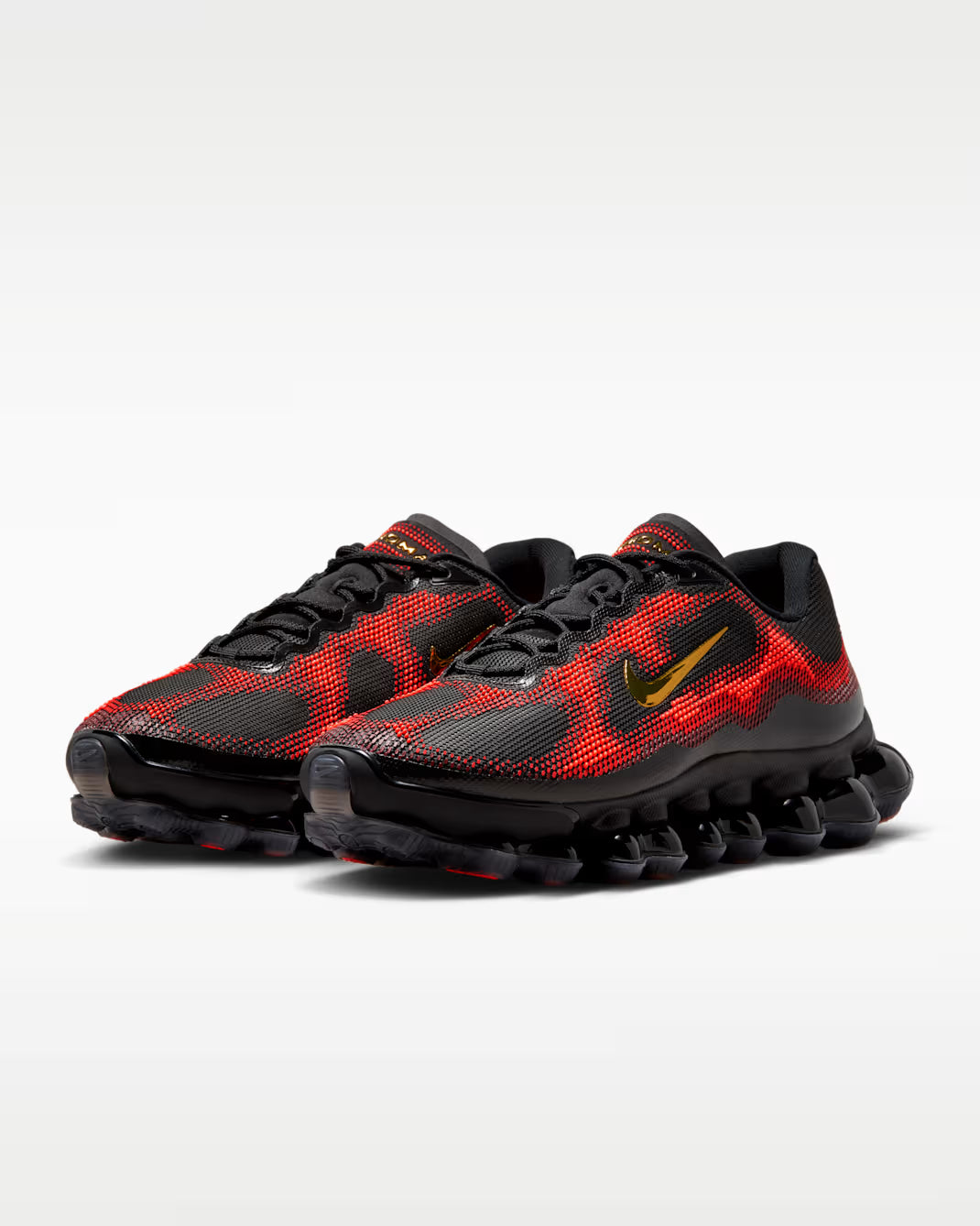 The Machina Wearable Technology Air Liquid Max 'Bright Crimson Fire Red' features a black sole and upper with Bright Crimson and Fire Red mesh overlays plus a yellow-outlined swoosh, shown against a white background.
