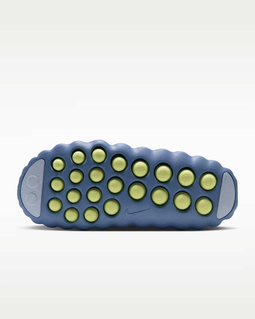 Mind 001 comfort footwear outsole in blue with lime green circular traction pods.