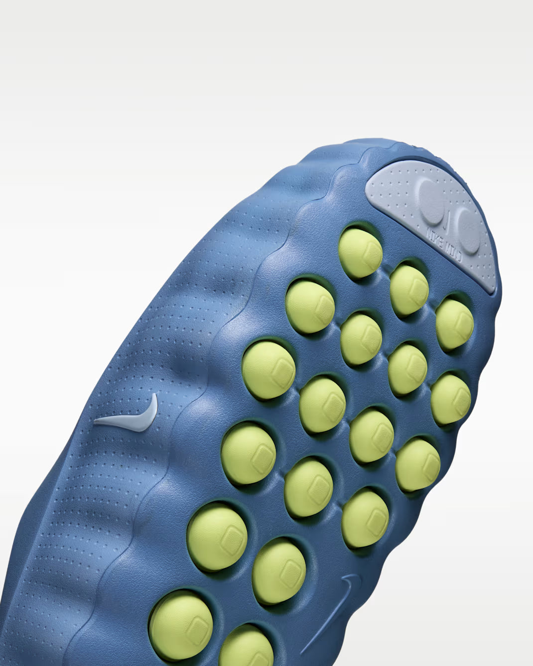 Close-up of the blue sensory outsole of a Mind 001 sneaker by Machina Wearable Technology, featuring protruding, rounded light-green traction pods.