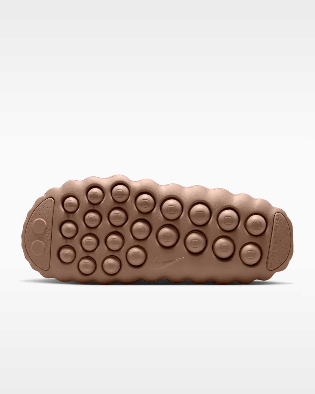 Light brown sensory sole of the Mind 001 sneaker featuring a pattern of raised, circular treads.