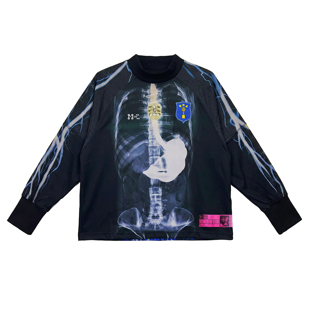 The AGUA MÁGICA long-sleeve by Machina - Wearable Technology features a human X-ray graphic, blue and white details, and two chest patches—one gold, one blue—for a bold look inspired by football folklore.