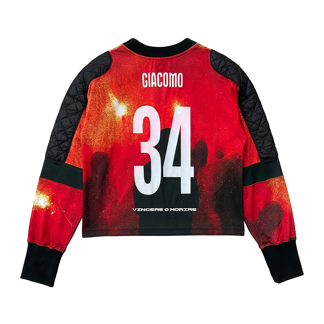 The Vincere o Morire jersey by Machina - Wearable Technology features a red and black 1934 World Cup–inspired design, GIACOMO and 34 on the back, a crowd, bright lights, and "VINCERE O MORIRE" near the hem honoring anti-fascist resistance.