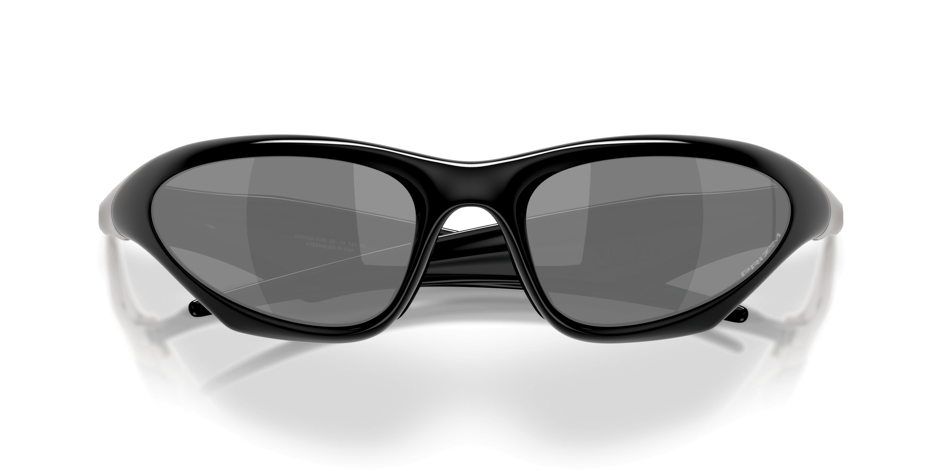The LIMITED-EDITION OAKLEY® MUZM SCAR by Machina - Wearable Technology features glossy, black, high-wrap sunglasses with large, rounded Prizm Black lenses on a white surface, viewed from the front.