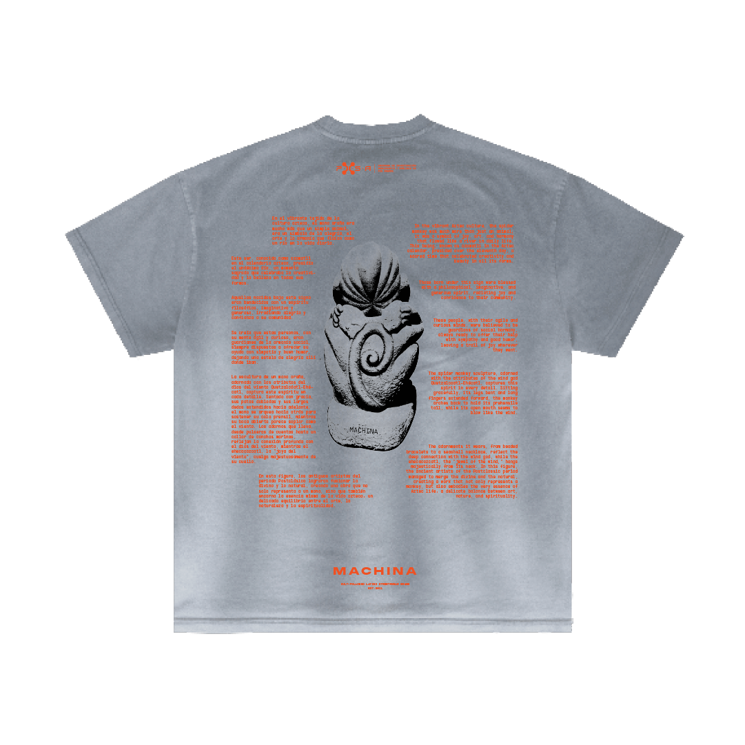 The back of the gray T-shirt features a central image inspired by Aztec culture, depicting a seated figure with a spiral design. The text surrounds the figure in red, with the word "Machina" at the bottom, capturing the intricate essence of an Ozomatli sculpture.