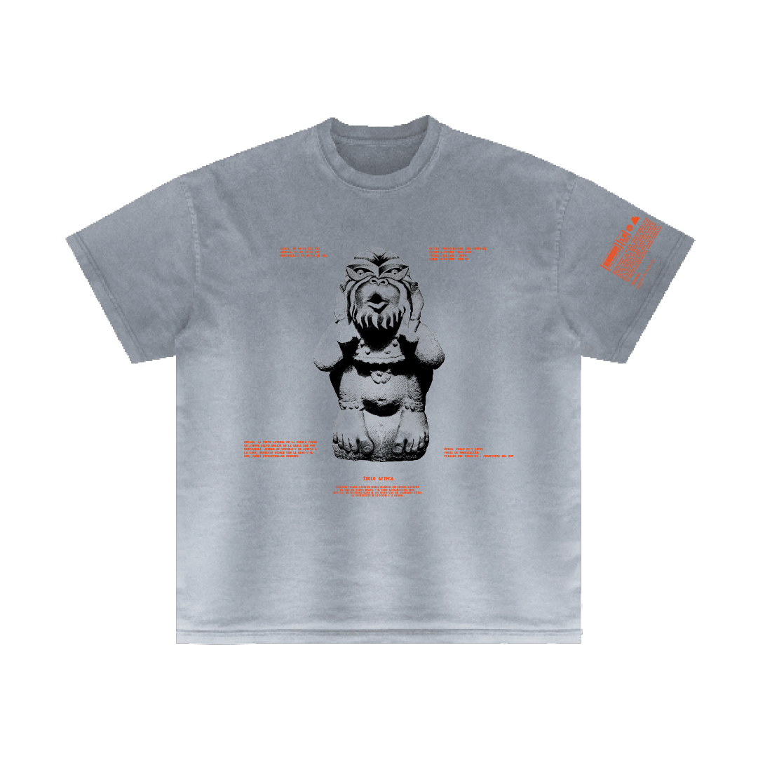 Ozomatli T-shirt by Machina - Wearable Technology, showcasing a centered graphic of a stylized, fierce-looking gargoyle statue inspired by Aztec culture. The design includes red text encircling the gargoyle and additional text on the left sleeve.