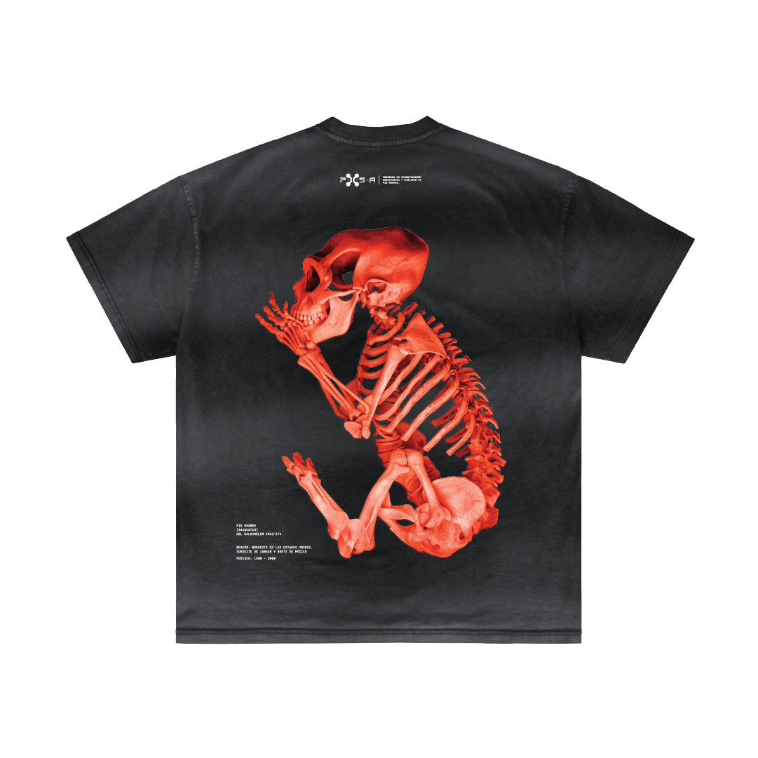 A black T-shirt from Machina - Wearable Technology features a red skeleton design on the back, depicting it in a fetal position reminiscent of a government experiment. The eerie motif is complemented by small white text and symbols scattered above and within, capturing the essence of "The Bigfoot Project.