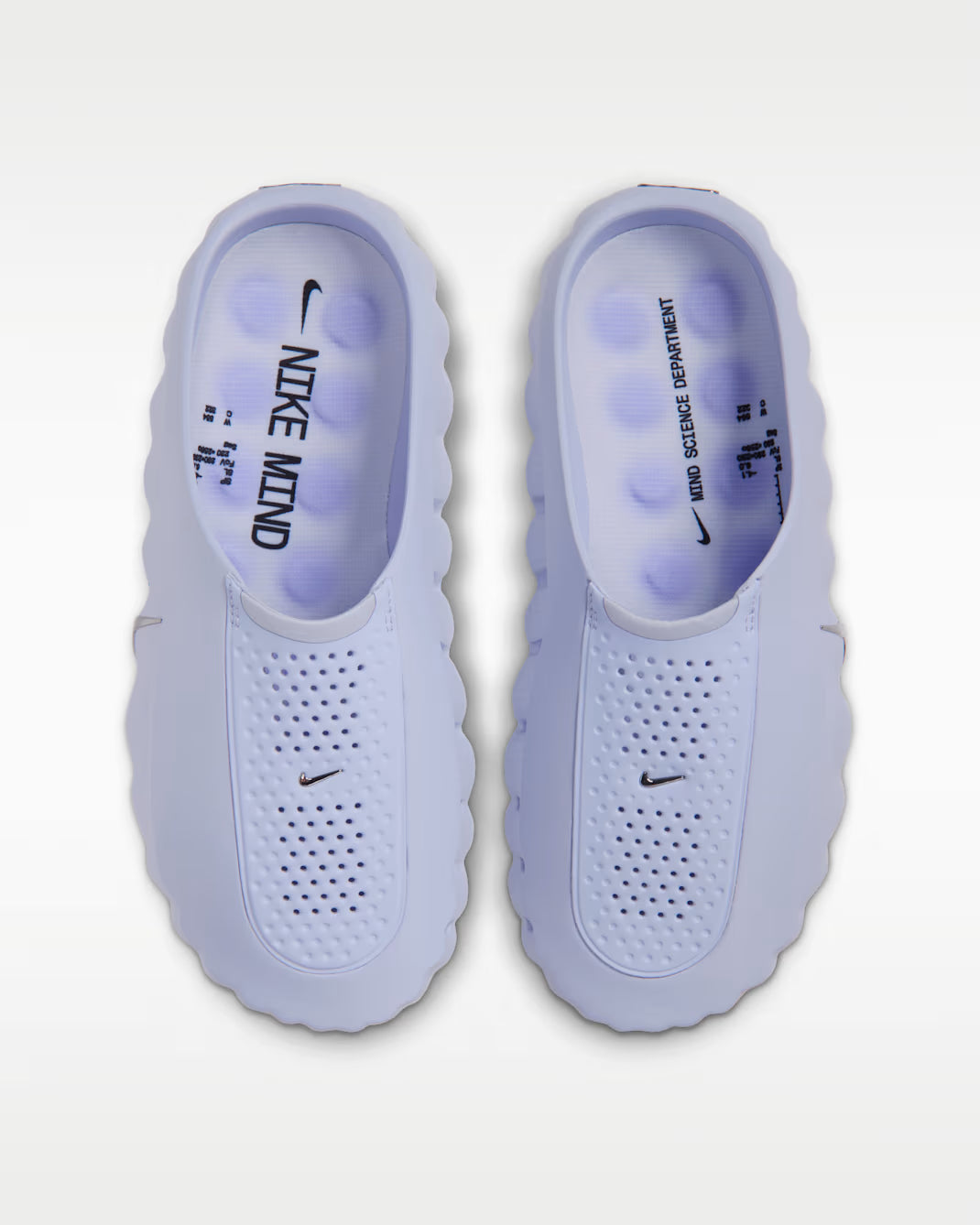 Lavender slip-on sensory Mind 001 sneakers by Machina Wearable Technology with perforated toe boxes and insoles reading NIKE MIND and MIND SCIENCE DEPARTMENT.