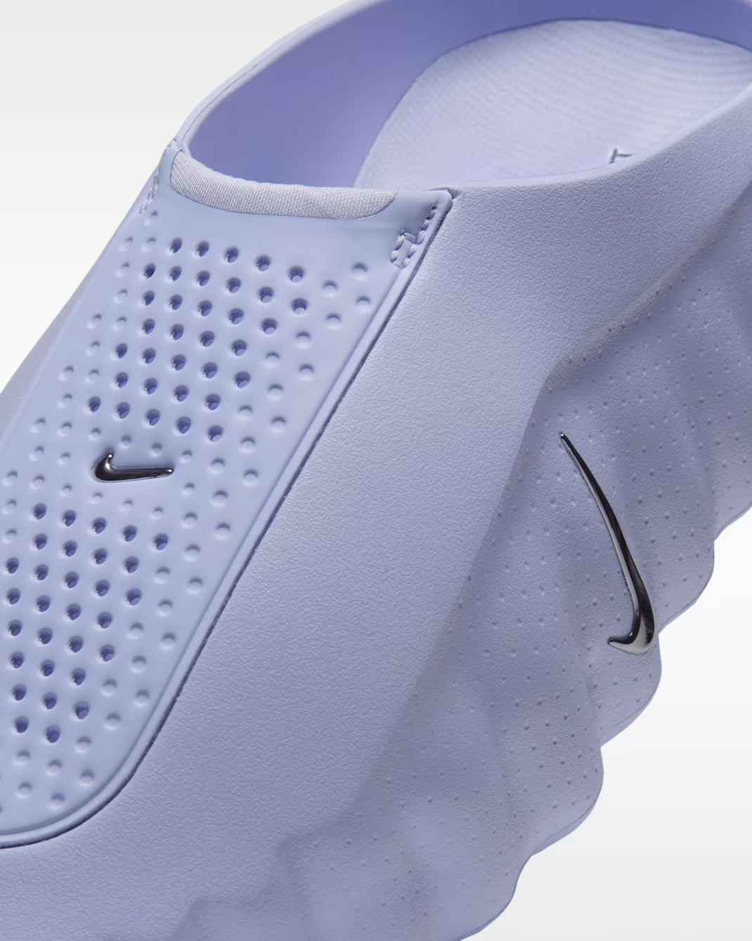 Close-up of a light purple Machina Wearable Technology Mind 001 sensory sneaker with a perforated slip-on upper and two small swoosh logos.
