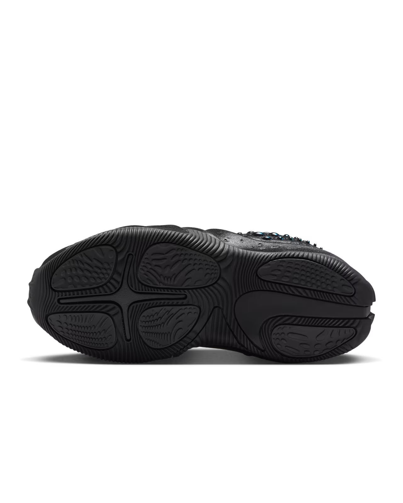 The Machina Wearable Technology First Sight Shadow Low in Black and Metallic Dark Grey is shown from the bottom, highlighting its textured rubber sole with deep grooves and patterns for traction—an ideal choice for women’s lifestyle footwear.