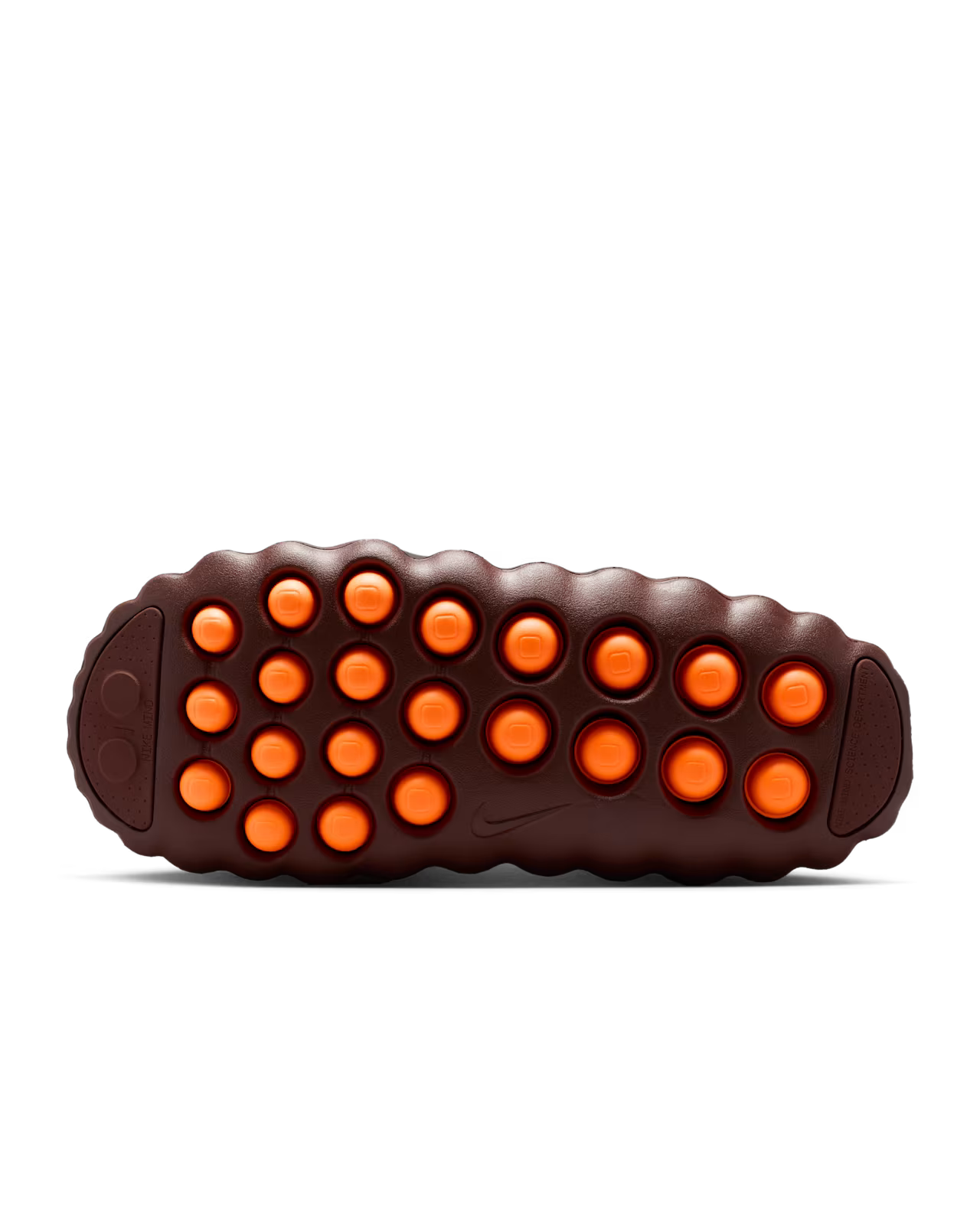 The image displays the sole of the Machina Wearable Technology Mind 001 Flyknit Bronze Eclipse, featuring a brown base with rows of circular orange protrusions for a modern, bold look.