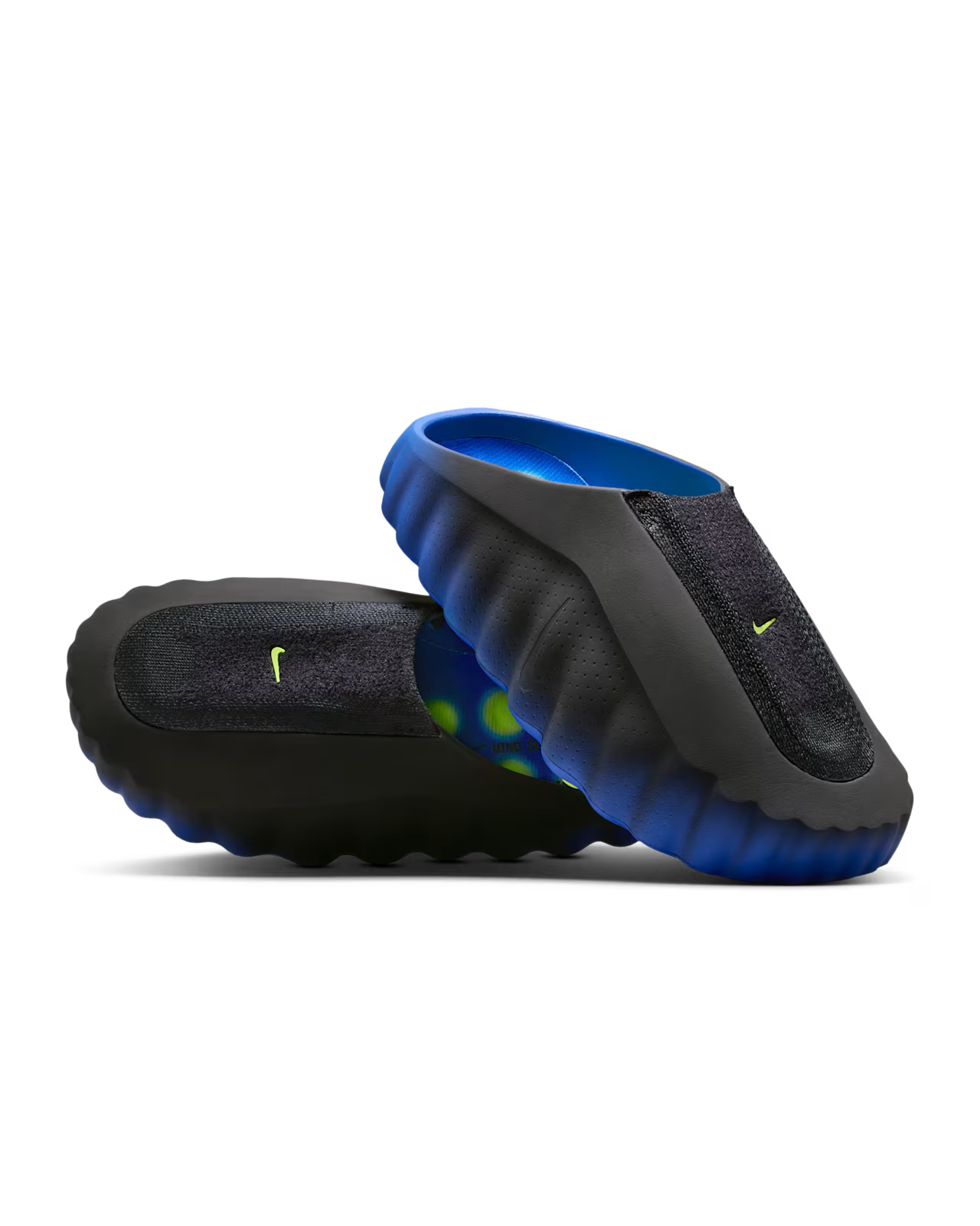 Two black and blue Machina Mind 001 Flyknit Hyper Royal slip-on shoes with wavy textured soles are stacked, featuring neon green Machina logos on top and a bright blue interior lining for a stylish finish.
