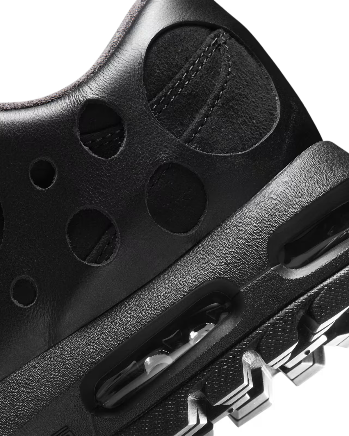 Close-up of the Air Max Goadome Low [Black] by Machina Wearable Technology, featuring circular cutouts and a section of the sole showcasing visible Air cushioning details and textured surfaces, inspired by the iconic Nike Air Max Goadome design.