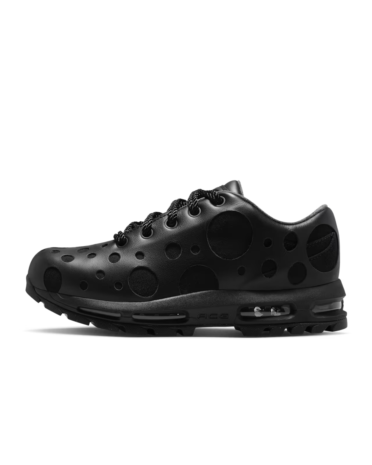 A black Air Max Goadome Low sneaker by Machina Wearable Technology, featuring a polka dot pattern, mesh laces, and visible Air cushioning in the sole, is shown in profile on a white background.