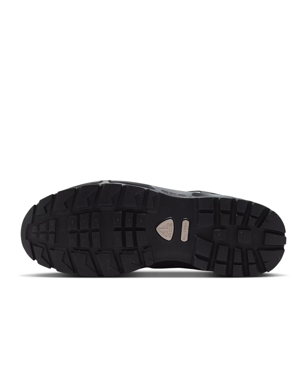 Black rugged shoe sole with deep, angular treads and a small metallic plate near the center, displayed against a white background—ideal for an outdoor boot like the Air Max Goadome Low in Light Orewood Brown and Black by Machina Wearable Technology, and crafted in versatile neutral tones to complement any adventure.