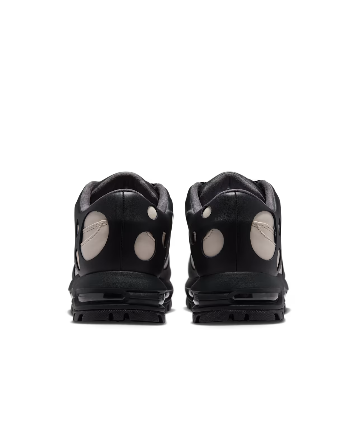 Rear view of a pair of Machina Wearable Technology Air Max Goadome Low sneakers in Light Orewood Brown and Black, featuring circular white cut-out designs on the heels, black soles with visible air cushioning, and accented with neutral tones for versatile outdoor wear.