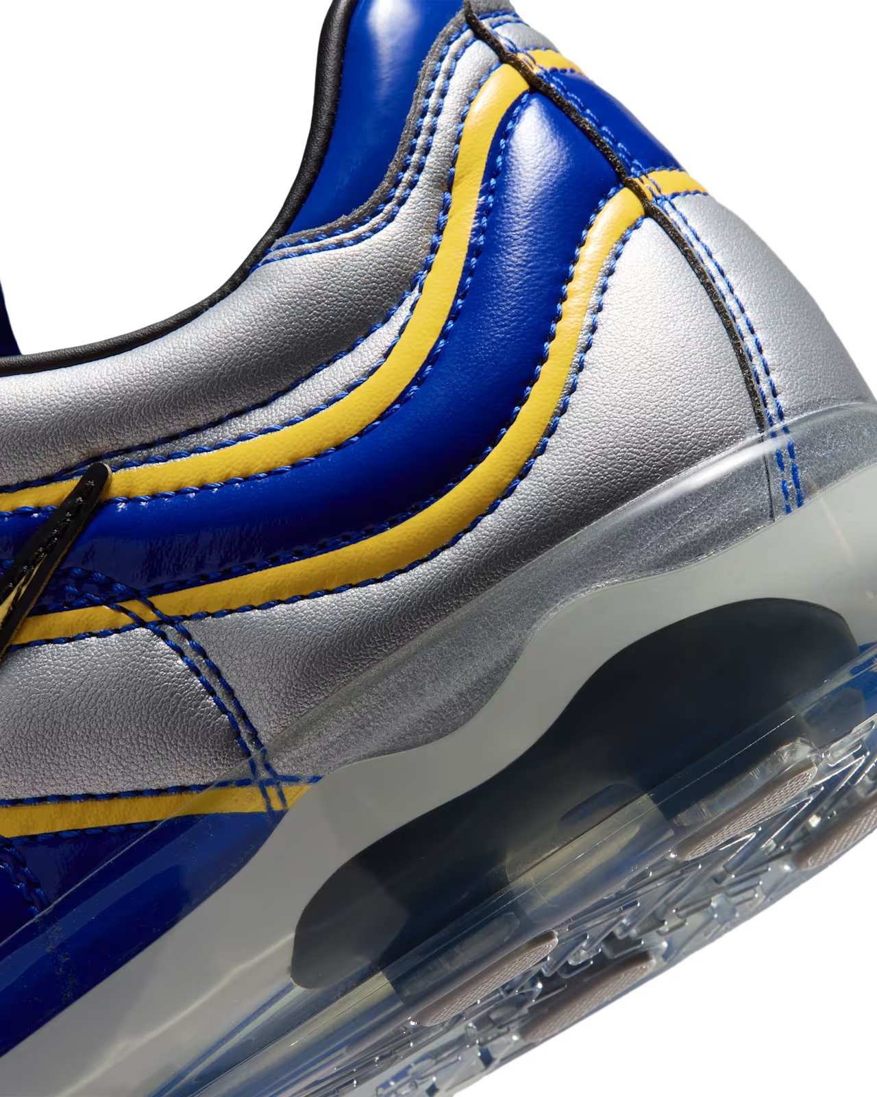 Close-up of the Cryoshot Mercurial Vapor R9 OG / PACOTE sneaker by Machina Wearable Technology in blue, silver, and yellow, featuring a transparent sole. The shoe’s stitching and wave-like color patterns are clearly visible, showcasing the design and materials in this online exclusive release.