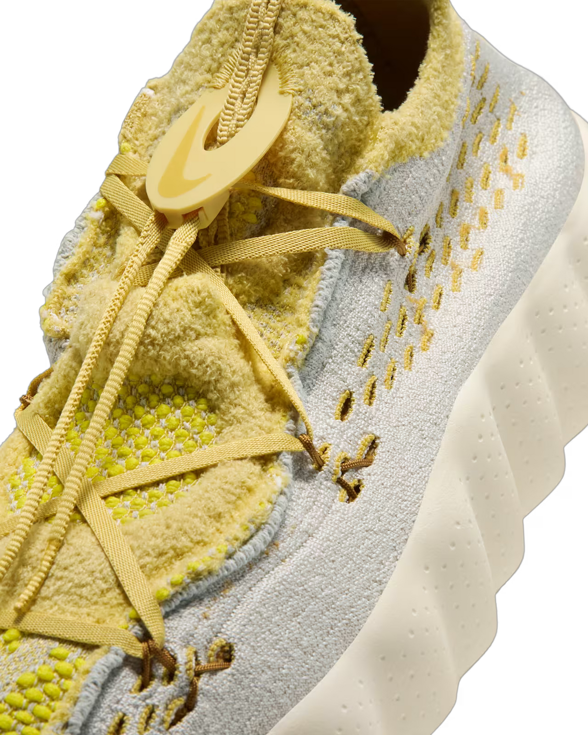 Close-up of the Machina Wearable Technology Mind 002 Light Bone and Saturn Gold sneaker featuring yellow laces, a textured yellow and white knit upper, and a thick white wavy sole with perforated yellow details—perfect for anyone seeking modern lifestyle footwear.