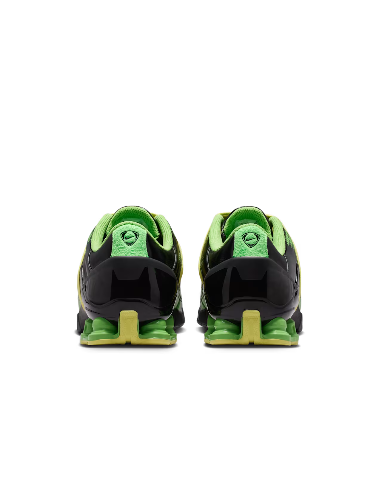 A pair of Total 90 Shox Magia Black and Yellow Diamond sneakers by Machina Wearable Technology is seen from the back, showcasing bright green uppers with black accents and greenish-yellow soles, positioned side by side on a plain white background.