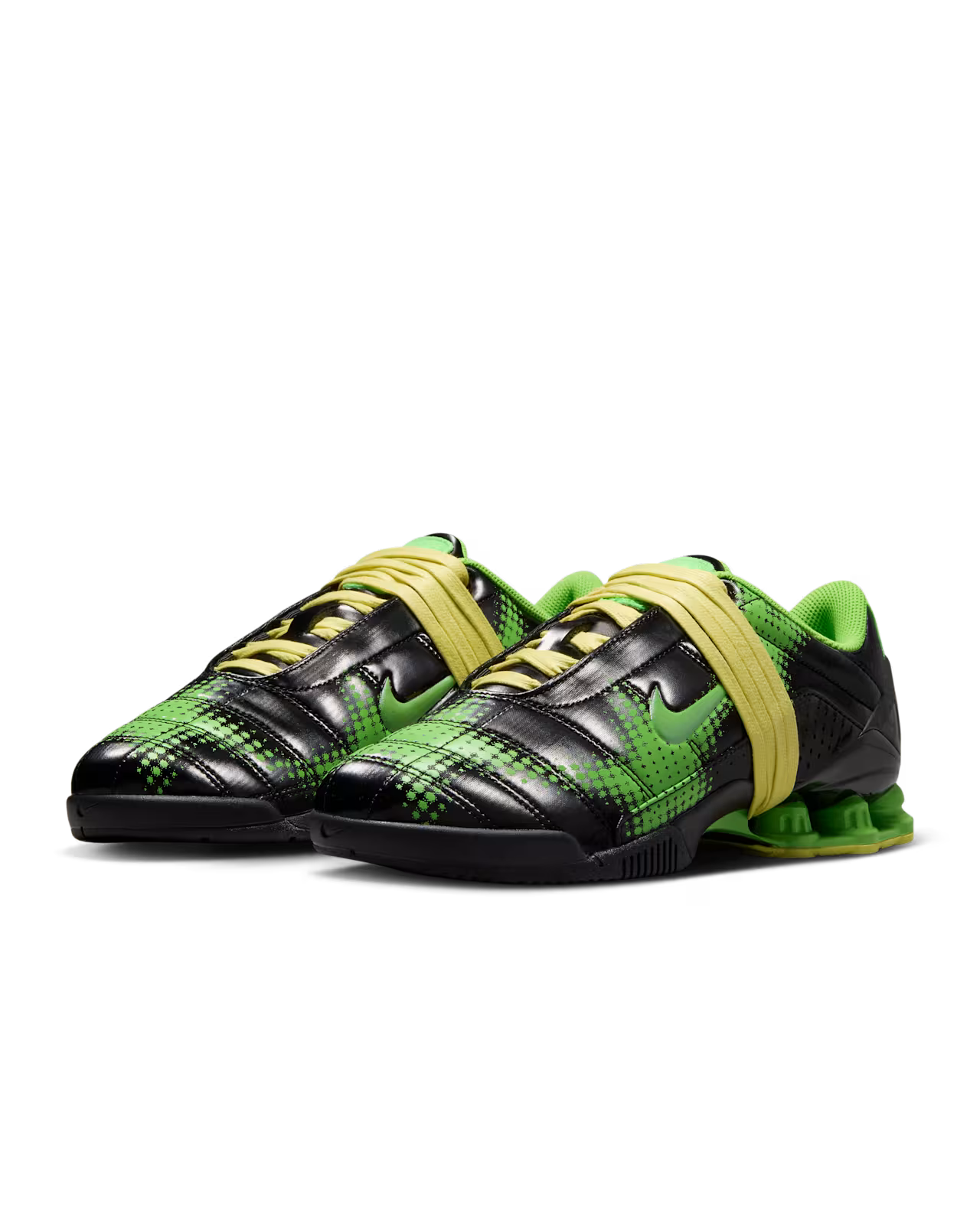 A pair of Machina Wearable Technology Total 90 Shox Magia Black and Yellow Diamond football shoes in black and green, with yellow laces, a green interior, unique heel design, patterned accents, and distinctive Black and Yellow Diamond detailing.