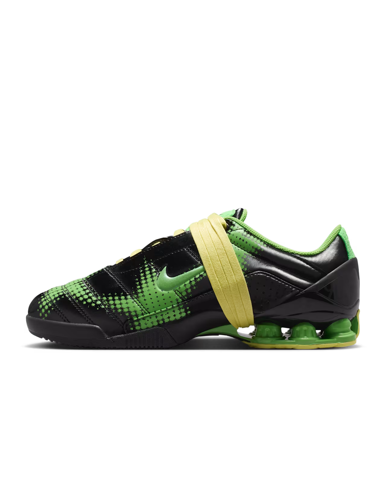 A left-side profile view of the Machina Wearable Technology Total 90 Shox Magia Black and Yellow Diamond sneaker is shown on a white background, featuring black and green uppers, yellow straps, and a visible green sole cushioning unit, inspired by the classic Nike Total 90 Shox Magia football shoe.