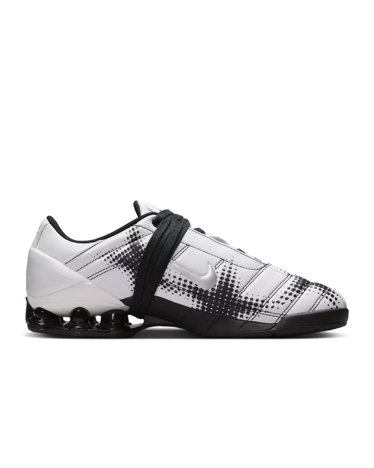 A white and black Machina Wearable Technology Total 90 Shox Magia sneaker featuring black dotted patterns, black laces, and a visible black air cushioning unit in the heel. The shoe showcases a sleek, modern design with geometric details inspired by classic football footwear.