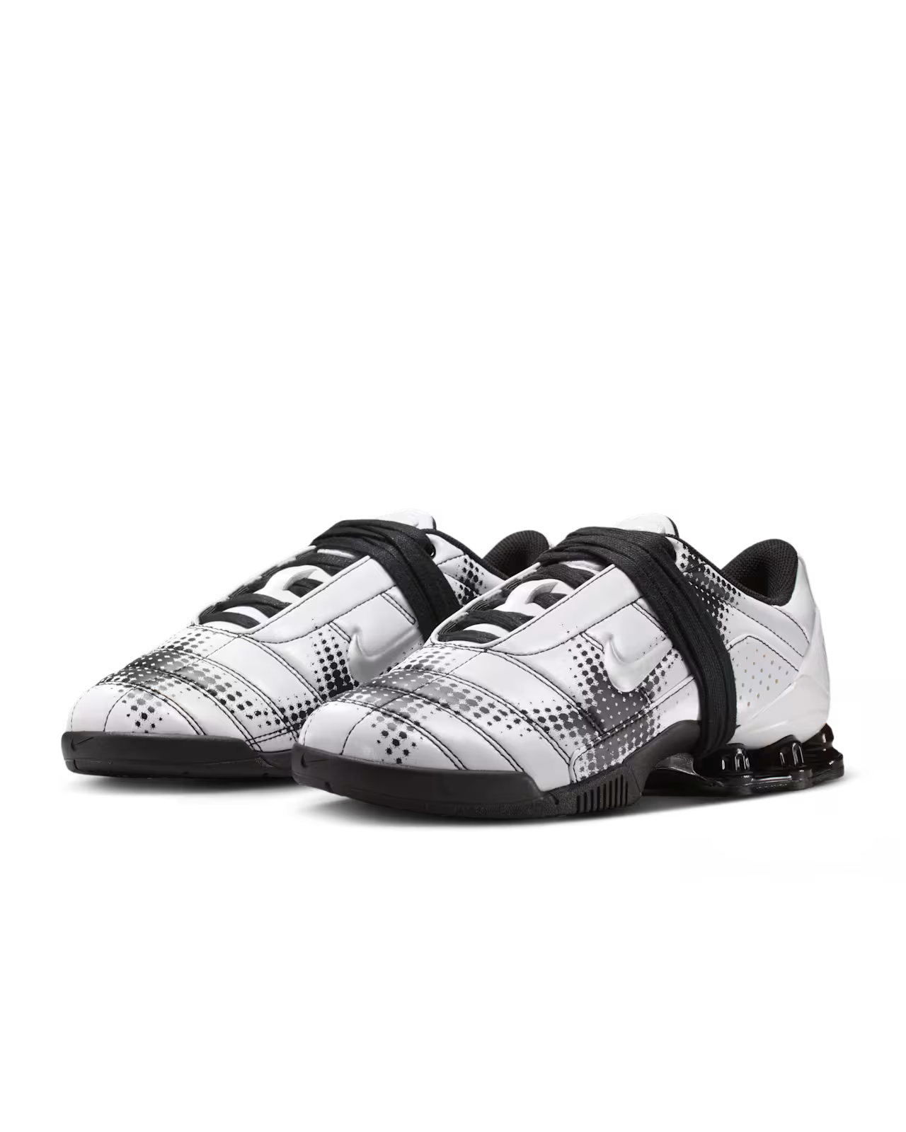 A pair of Machina Wearable Technology Total 90 Shox Magia White and Black football shoes with silver accents, featuring a distinctive strap design, visible Shox columns in the heel, and patterned detailing across the upper.